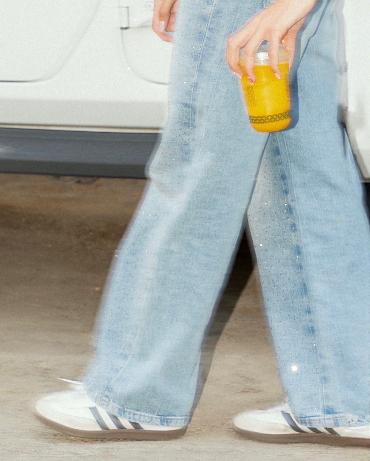 Guest heading out of Deja Brew Coffee Bar with a signature cooler in hand