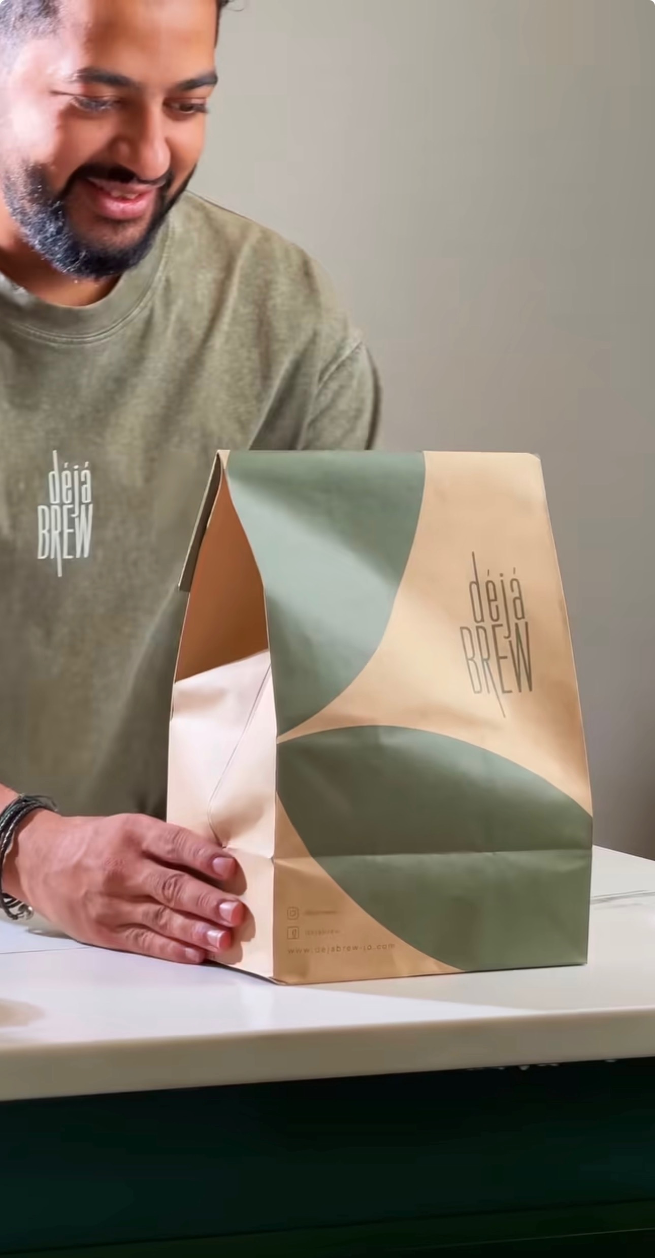 A one-kilo bag of Deja Brew roasted coffee beans handed over the counter